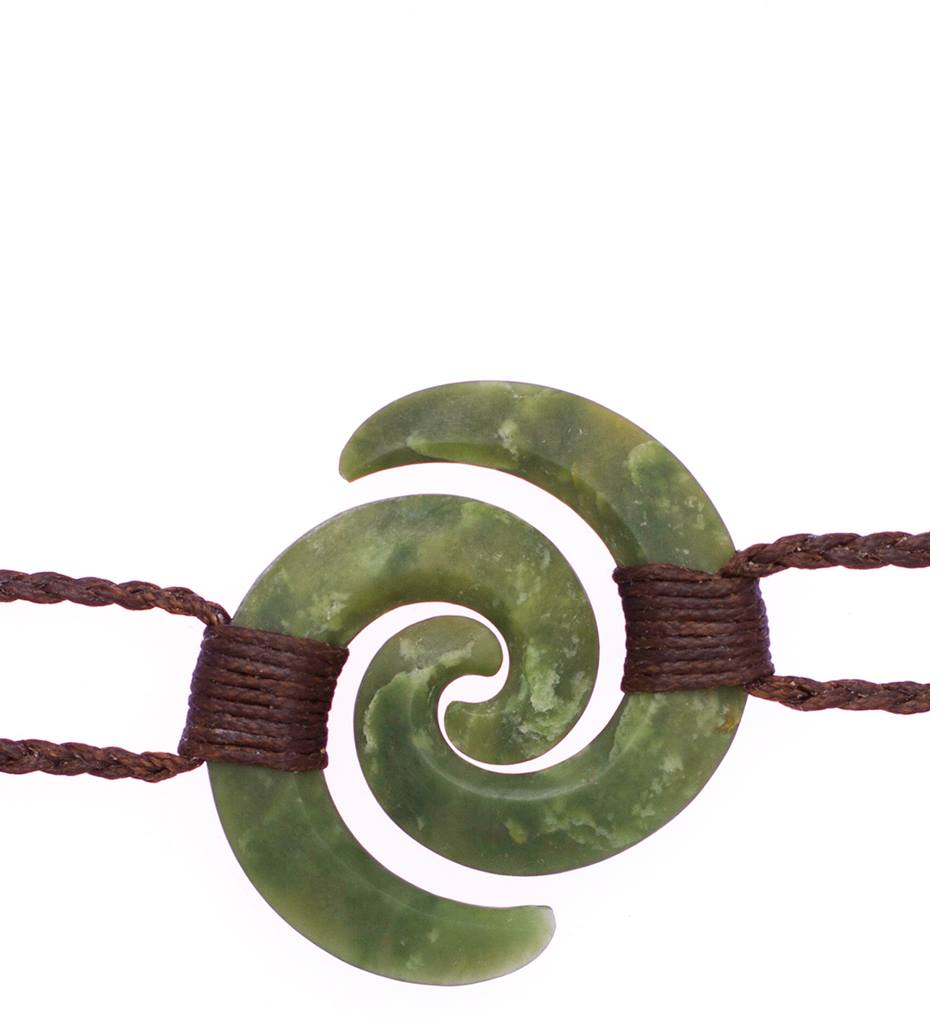 A pair of matching green pounamu koru pendants on braided cords